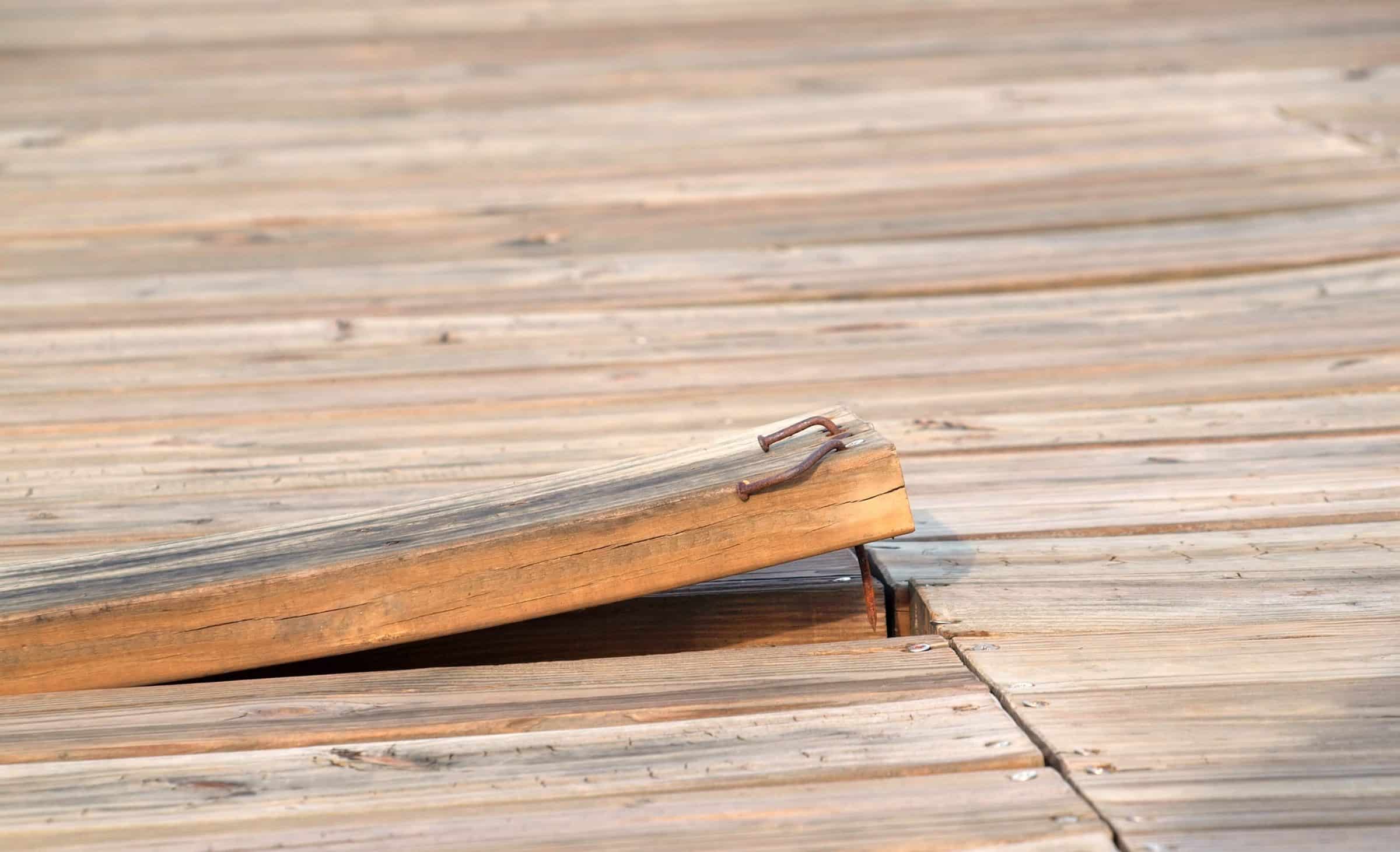 rusting nails in a loose deck board